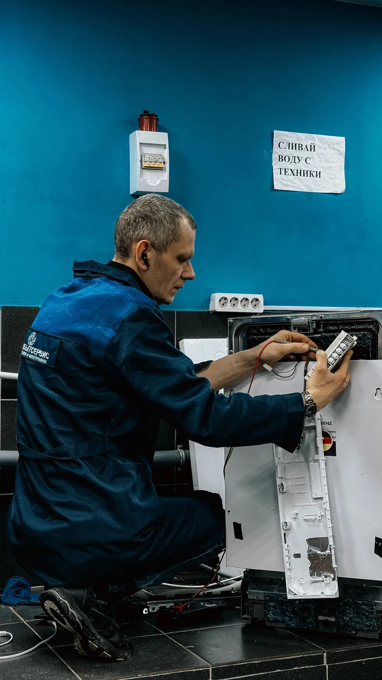 Technician servicing a home appliance