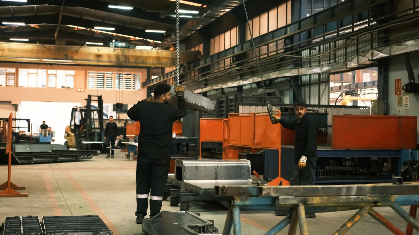 Workers operating factory machinery