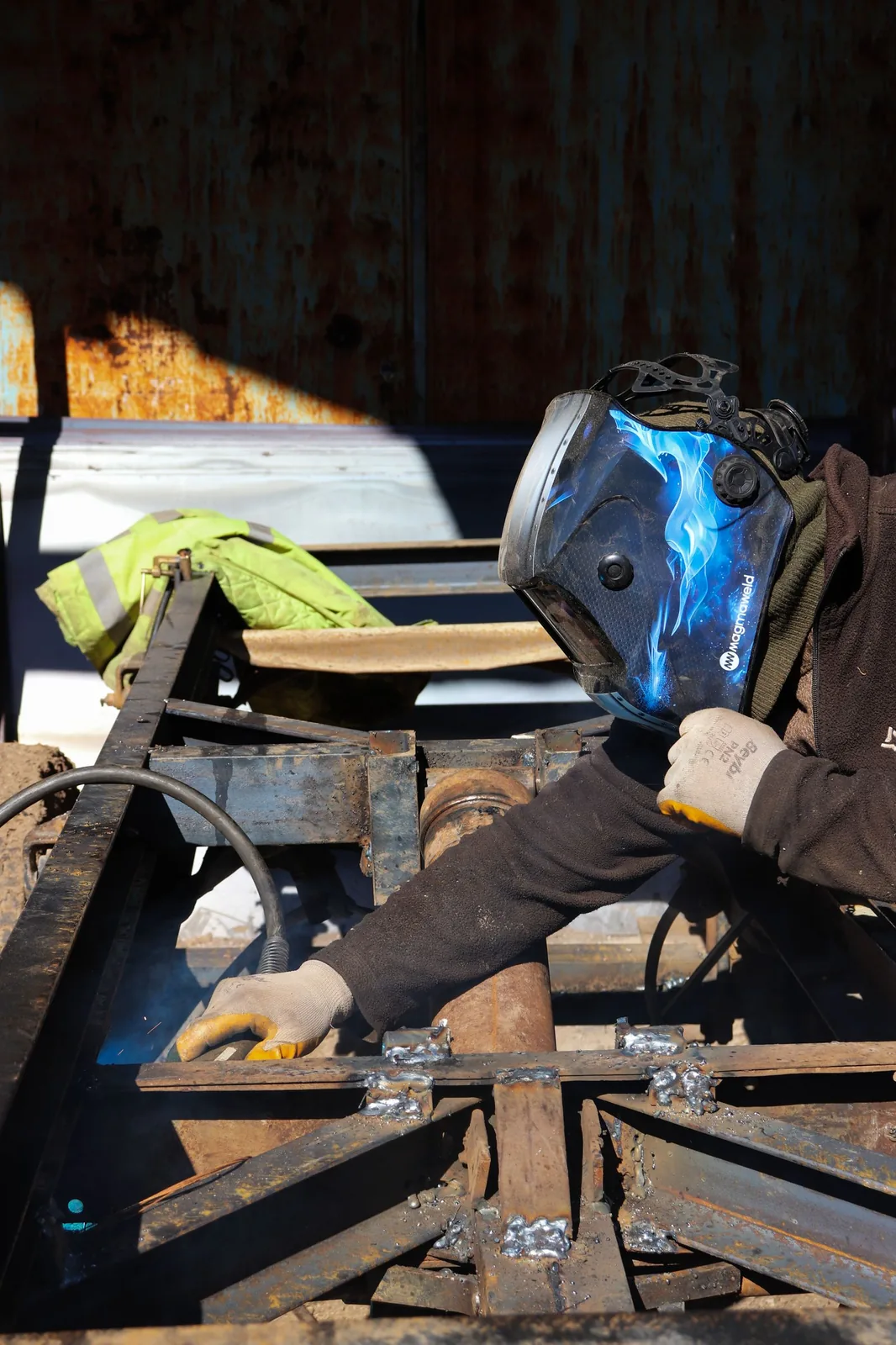 Welder fabricating a steel frame