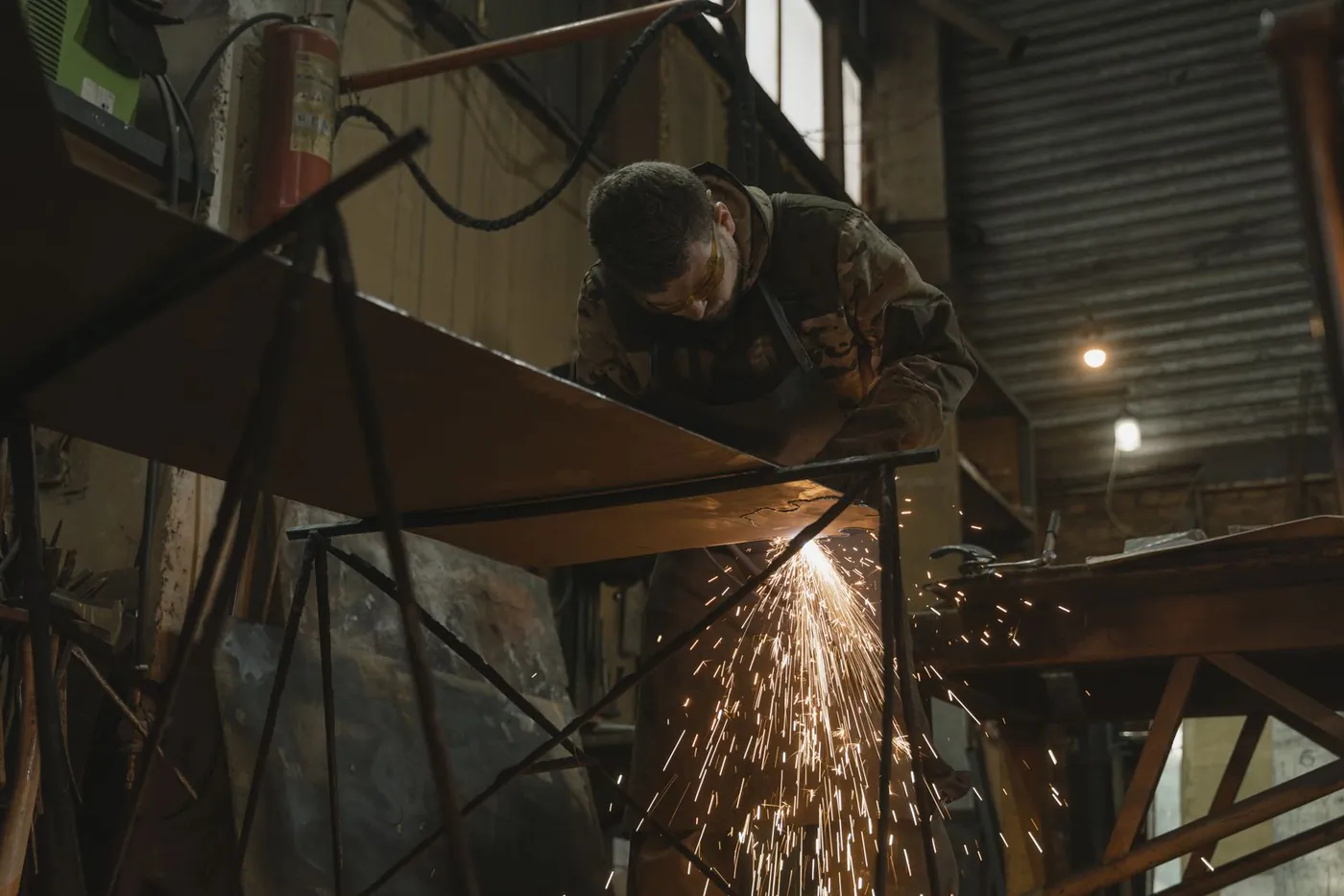 Welder working on a metal bar